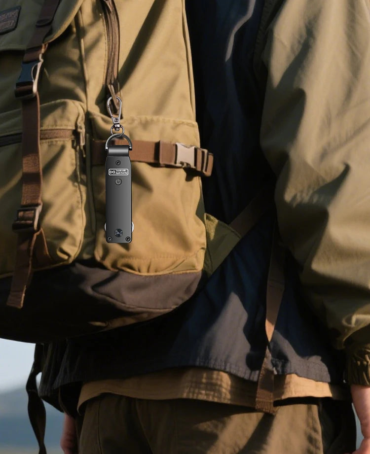 NURVION keychain clipped to a backpack strap with a carabiner clip, worn outdoors