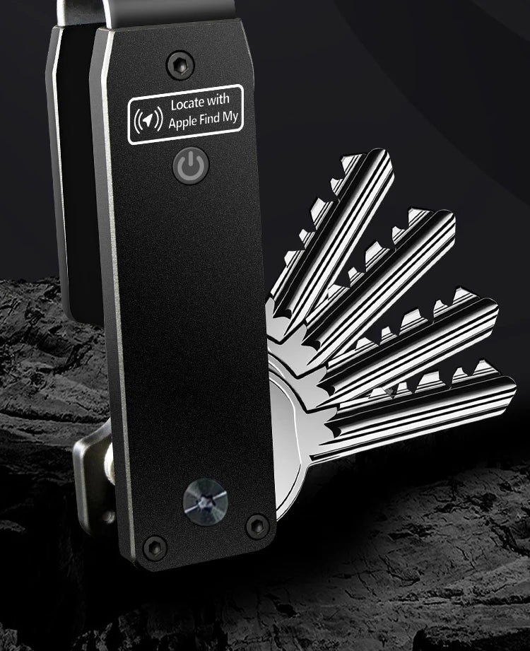 Close-up of the NURVION keychain in black finish attached to a full set of keys against a dark background